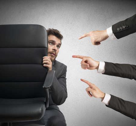 Concept of businessman culprit behind a chairの写真素材