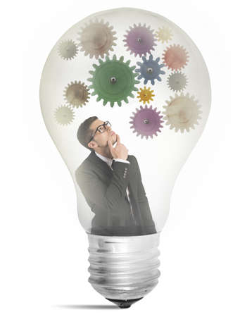 Businessman thinking about new idea inside a lampの写真素材