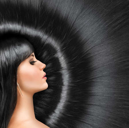 Long shiny hair of a beautiful young brunetteの写真素材