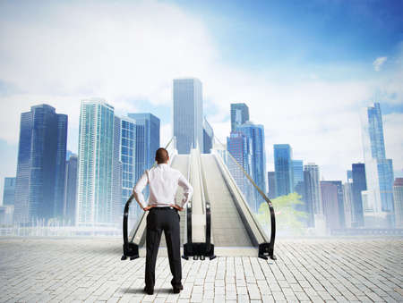 Businessman in front of a stairs to successの写真素材