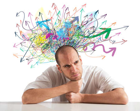 Confusion of a businessman with colorful arrowの写真素材