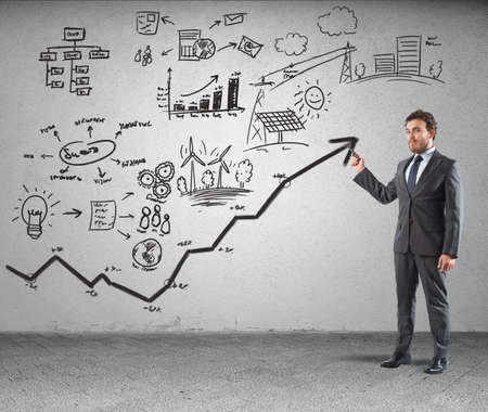 Businessman drawing strategy in a wallの写真素材