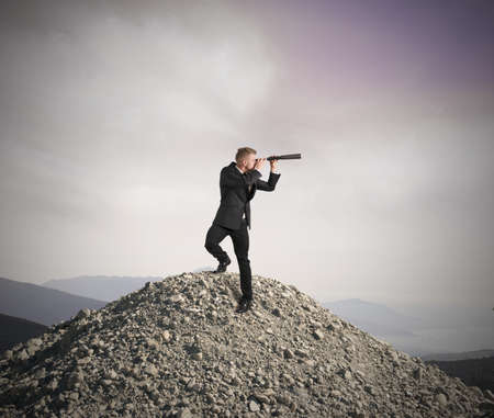 Concept of business vision with businessman with telescopeの写真素材