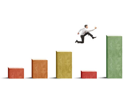 Businessman skips the crisis with a jump on a positive statisticの写真素材