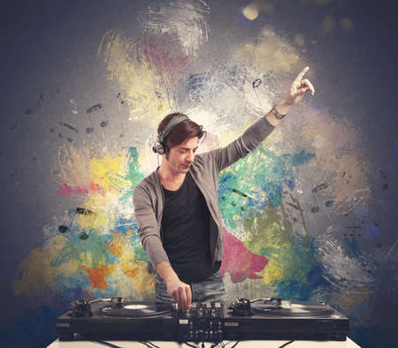 DJ at work playing music with a mixerの写真素材