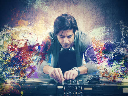 DJ at work playing music with a mixerの写真素材