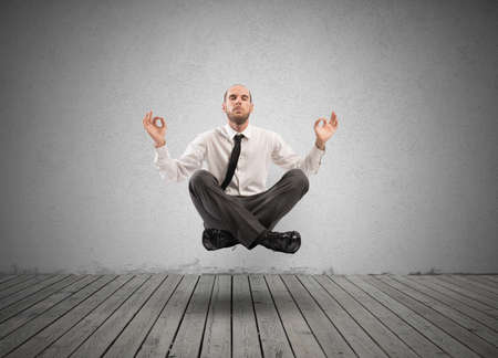 Concept of relax with businessman doing yogaの写真素材