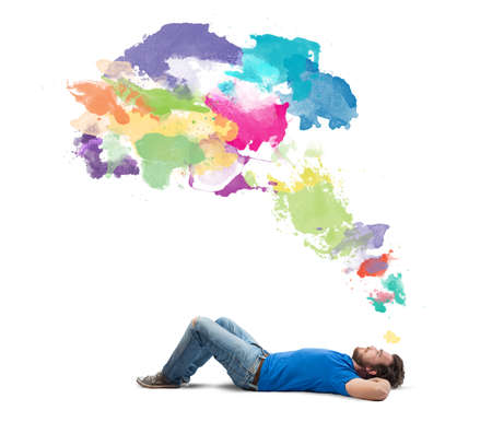 Lying boy think creative with colorful splashの写真素材
