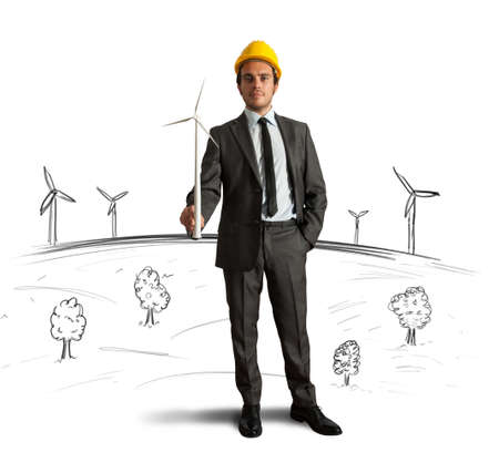 Businessman thinks about wind turbine energy projectの写真素材
