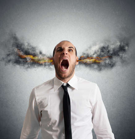 Stressed businessman with smoke and flame in head