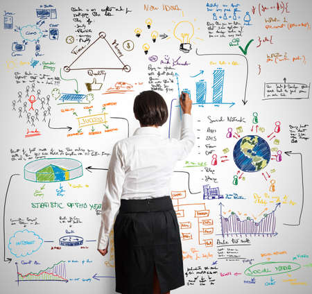 Businesswoman draws sketch of business projectの写真素材