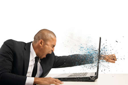 Concept of stress and frustration of a businessman with laptopの写真素材