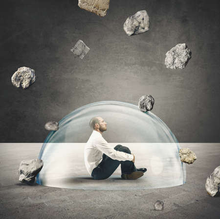 Businessman protected from the crisis with a crystal ballの写真素材