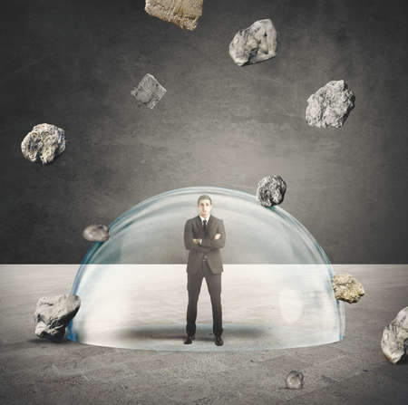 Businessman protected from the crisis with a crystal ballの写真素材