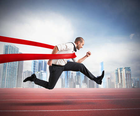 Successful businessman on the finishing line of a trackの写真素材