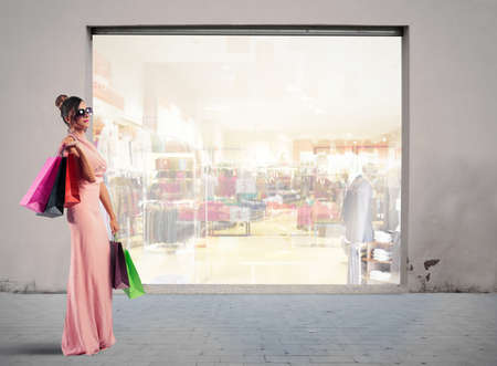Beautiful young woman holding shopping bagsの写真素材