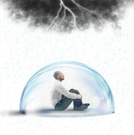 Businessman protected from the crisis with a crystal ballの写真素材