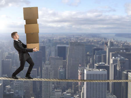 Concept of difficult career in business with businessman on the ropeの写真素材