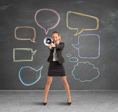 Concept of new message with businesswoman with megaphoneの写真素材