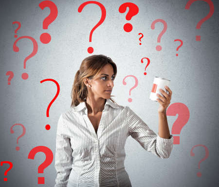 Girl at supermarket with doubt about foodの写真素材