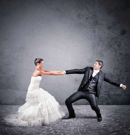 Woman holds man wants to escape from marriageの写真素材