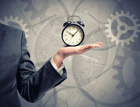 Concept of time with businessman that hold an alarm clock Concept of time with businessman that hold an alarm clock