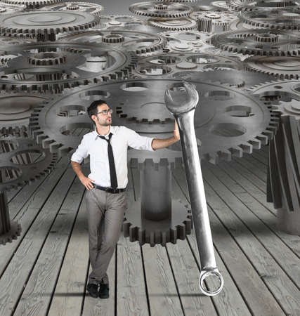 Businessman makes maintenance of a system of gearsの写真素材