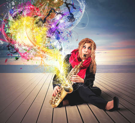 Girl saxophonist with colorful sound effectの写真素材