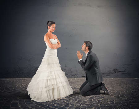 Wife forgives her husband at their weddingの写真素材