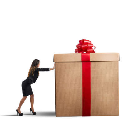 A businesswoman pushing a big Christmas giftの写真素材