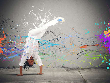 Brazilian man dressed in white dancing capoeiraの写真素材