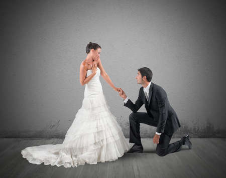 Husband kneels for a romantic marriage proposalの写真素材