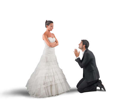 Wife forgives her husband at their weddingの写真素材