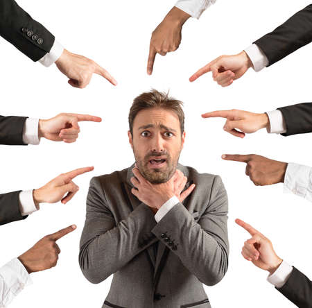 Businessman accused and insulted by his teamの写真素材