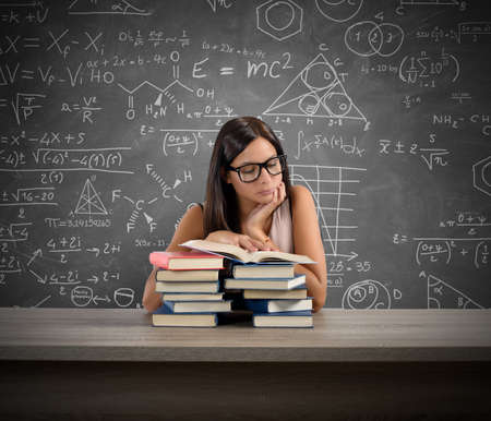 A young teacher concentrated reading a bookの写真素材