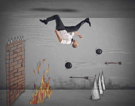 Businessman runs to overcome obstacles to workの写真素材