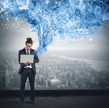 In a skyscraper businessman work with laptop
