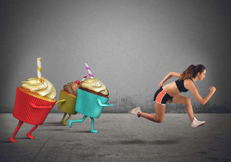 Woman runs away from sweets to dietの写真素材