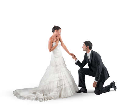 Husband kneels for a romantic marriage proposalの写真素材