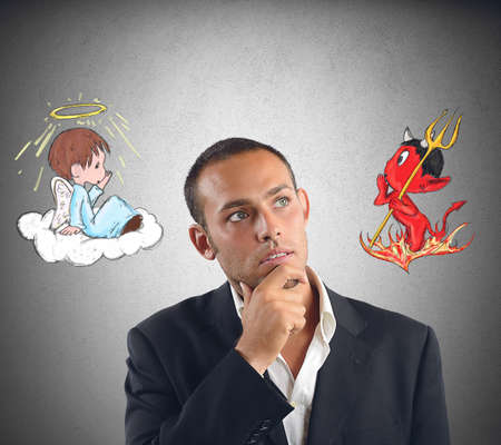 A businessman undecided between good and evilの写真素材