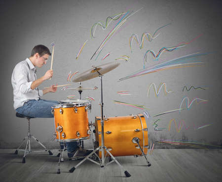 A drummer plays his instrument producing notesの写真素材