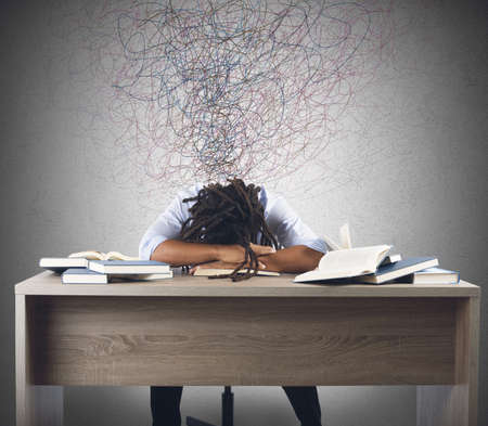 Man tired of studying dreaming over books