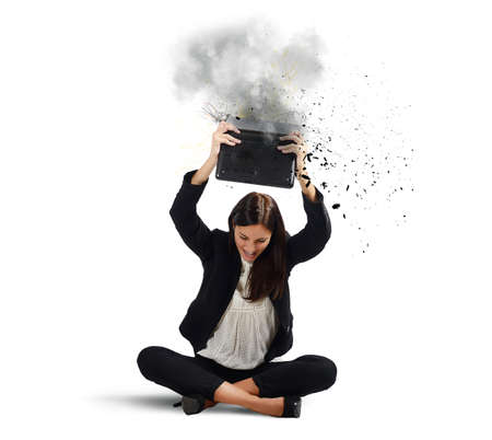 Businesswoman stressed from work breaks her laptopの写真素材