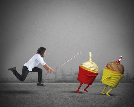 Man on diet against sweets and fatsの写真素材