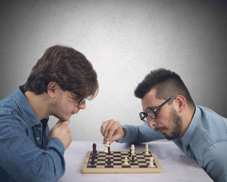 Two brothers play and compete in chess gameの写真素材