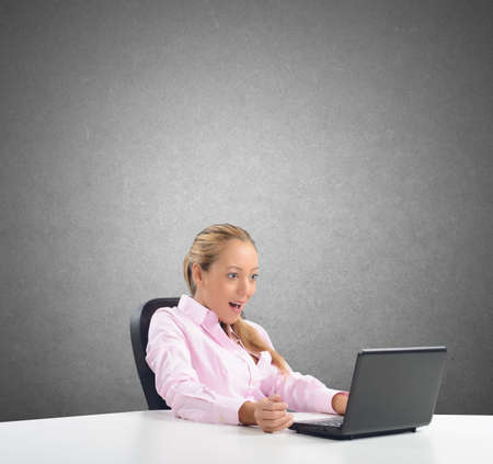 Businesswoman amazed by its budget on laptopの写真素材