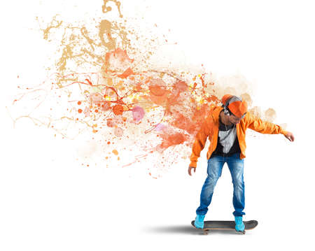 Boy with skate leaves a coloured trailの写真素材