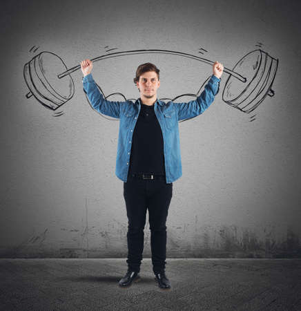Surprisingly strong guy lifts weights with dumbbellの写真素材