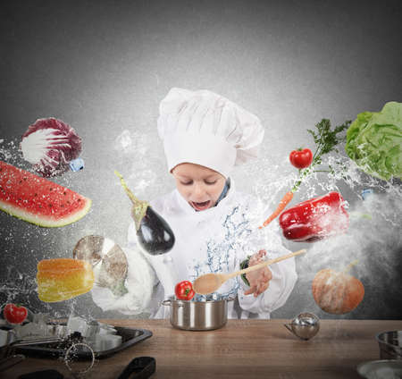 Little child chef playing and having funの写真素材