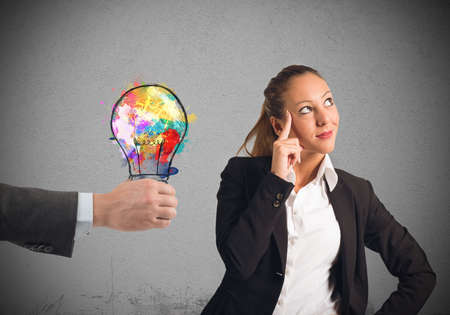 Colleague suggests an idea to a businesswomanの写真素材